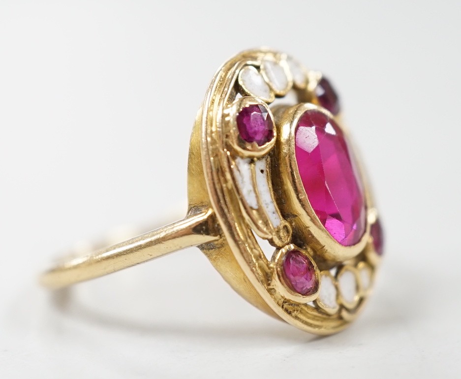 An 18ct, white enamel and four stone synthetic? ruby set oval dress ring, size N, gross weight 3.9 grams.